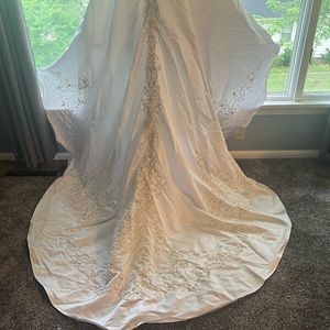 Beautiful white sequins,embroidery and pearls.Cathedral train with bustle